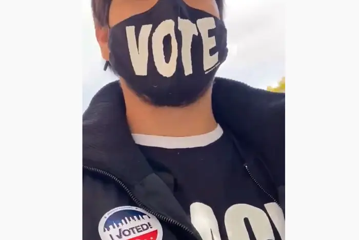 A seflie of a State Senate staffer wearing a VOTE mask and a Black Lives Matter shirt.